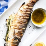 Grilled whole branzino with lemon caper sauce. Find all the tips you need for grilling and serving whole fish.