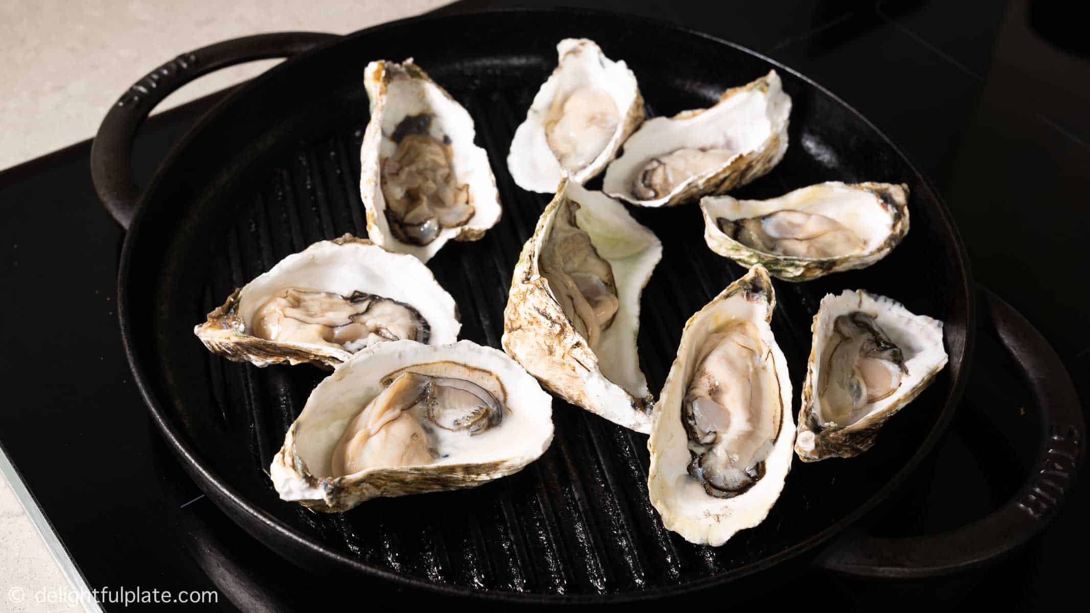 oysters on a grill pan, uncovered