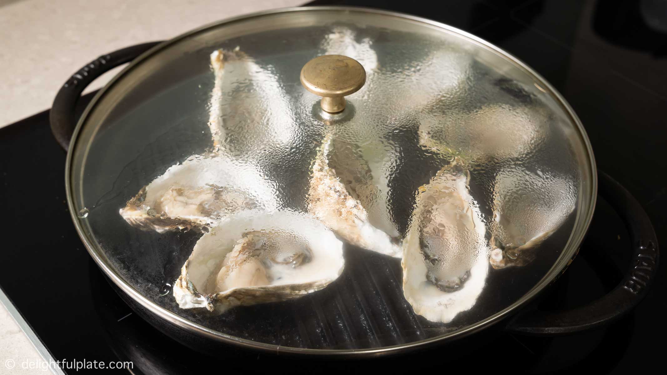 oysters on a grill pan, covered