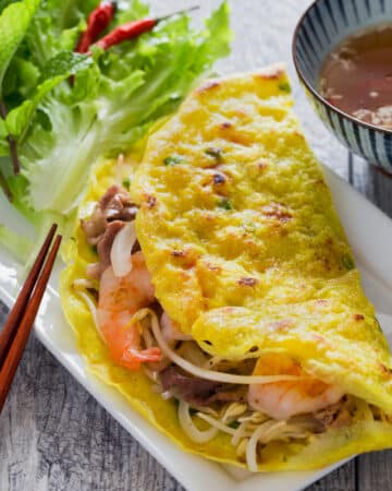 Vietnamese Crepe (Banh Xeo) is crispy, light and filled with shrimp, pork, and crunchy vegetables. It is very quick and easy to make. Serve it with fresh herbs and refreshing lime fish dipping sauce as a snack, appetizer or main dish.