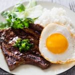 Vietnamese grilled lemongrass pork chops served with a fried egg and rice.