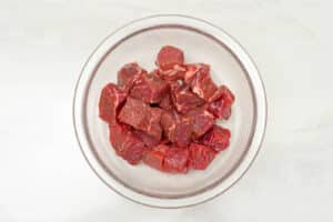 diced beef cubes in a mixing bowl.