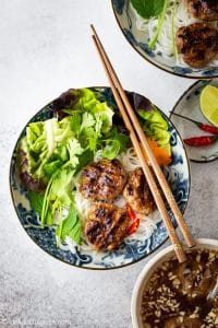 Vietnamese Grilled Pork Meatballs with Vermicelli Noodles (Bun Cha) is a classic Northern Vietnamese dish. Bun Cha features flavorful and juicy pork meatballs, vermicelli noodles, plenty of refreshing herbs and traditional lime fish sauce dipping.