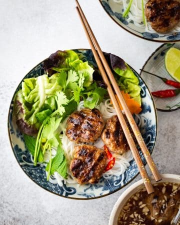 Vietnamese Grilled Pork Meatballs with Vermicelli Noodles (Bun Cha) is a classic Northern Vietnamese dish. Bun Cha features flavorful and juicy pork meatballs, vermicelli noodles, plenty of refreshing herbs and traditional lime fish sauce dipping.