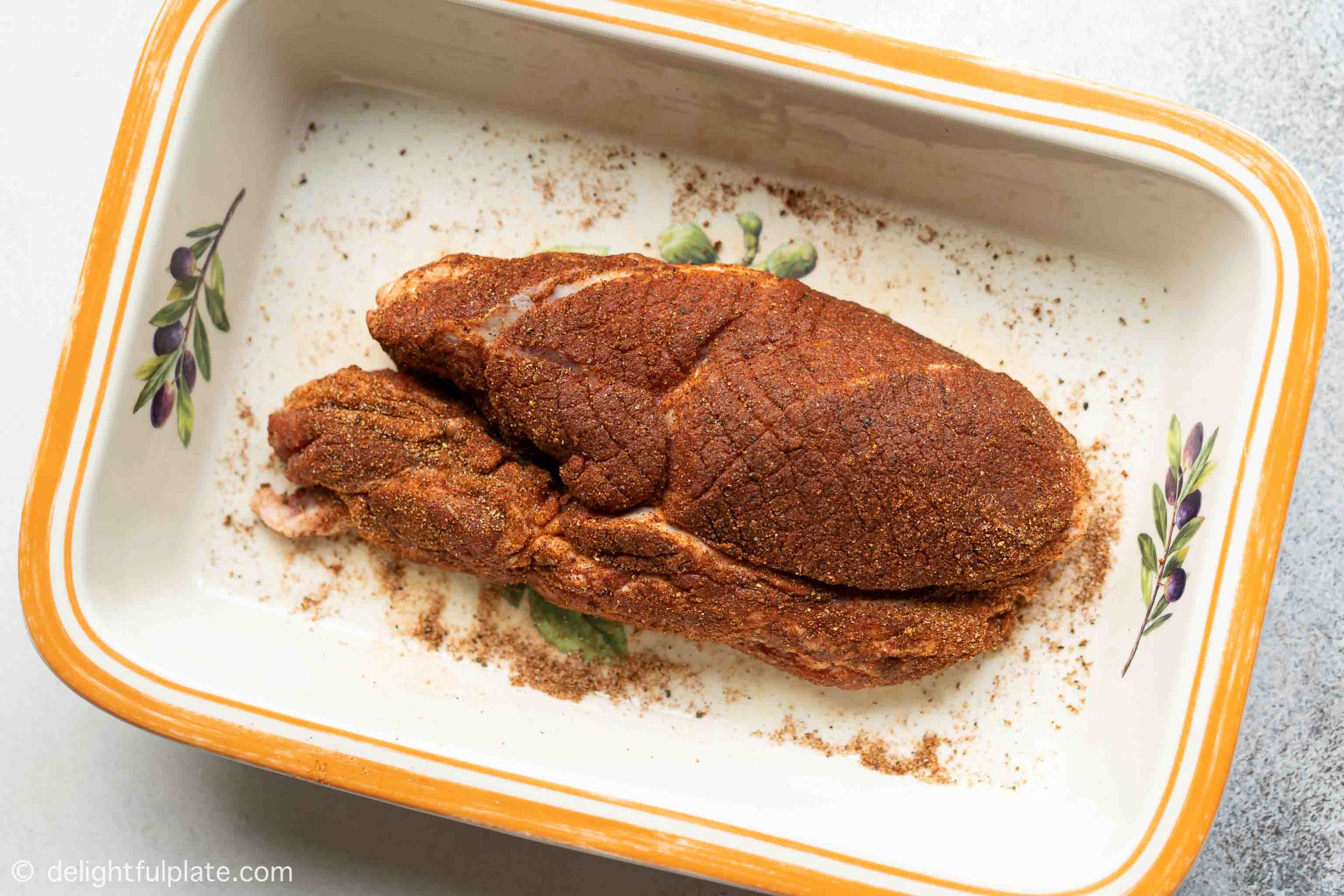 a pice of pork shoulder with dry rub