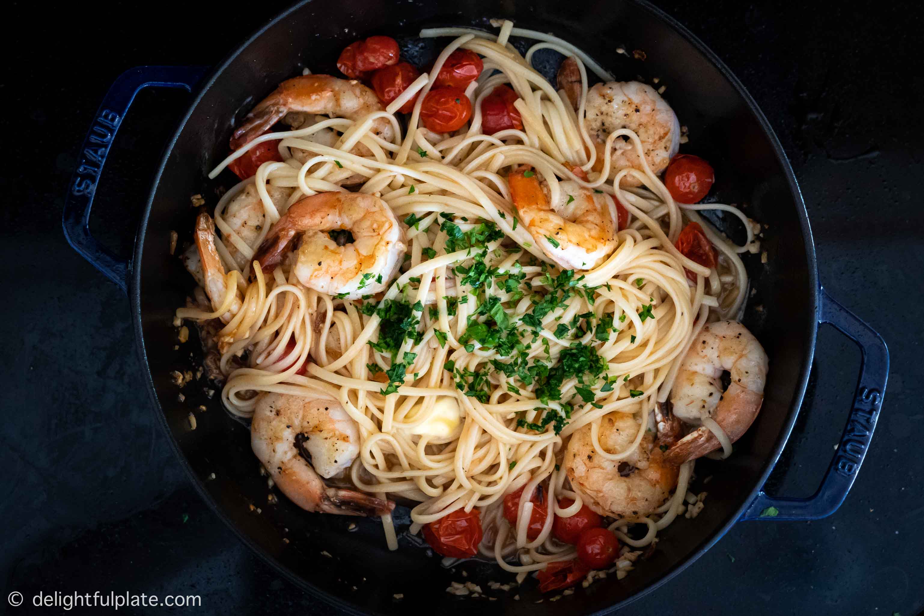 cooking shrimp and scallop pasta in a pan