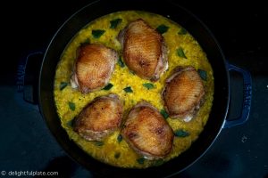 Cooking chicken and turmeric rice: put chicken on top of rice and put everything in the oven to bake