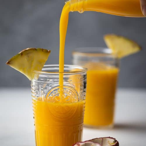 This Tropical Pineapple Mango Smoothie is a tasty and healthy drink with a pleasant sweet fruity scent. Made with fresh mango, pineapple, passion fruit and coconut juice, it is dairy-free with no added sugar.