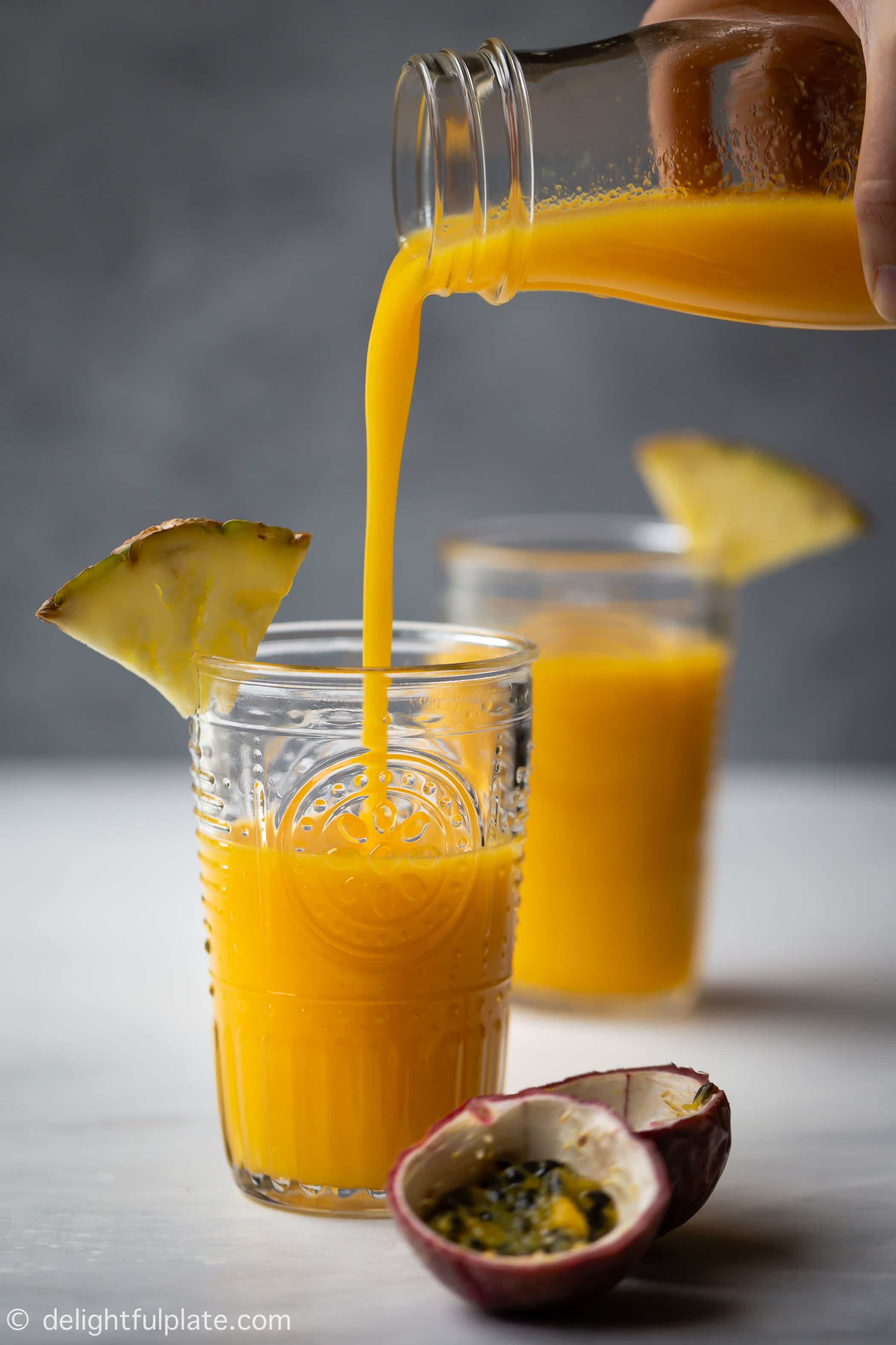 This Tropical Pineapple Mango Smoothie is a tasty and healthy drink with a pleasant sweet fruity scent. Made with fresh mango, pineapple, passion fruit and coconut juice, it is dairy-free with no added sugar.