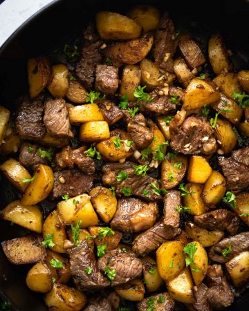 This Asian Steak Bites and Potatoes recipe features seared beef cubes and potatoes in a garlicky butter and soy-based sauce. It comes together in under 30 minutes and everything is cooked in just one pan. Easy weeknight dinner!