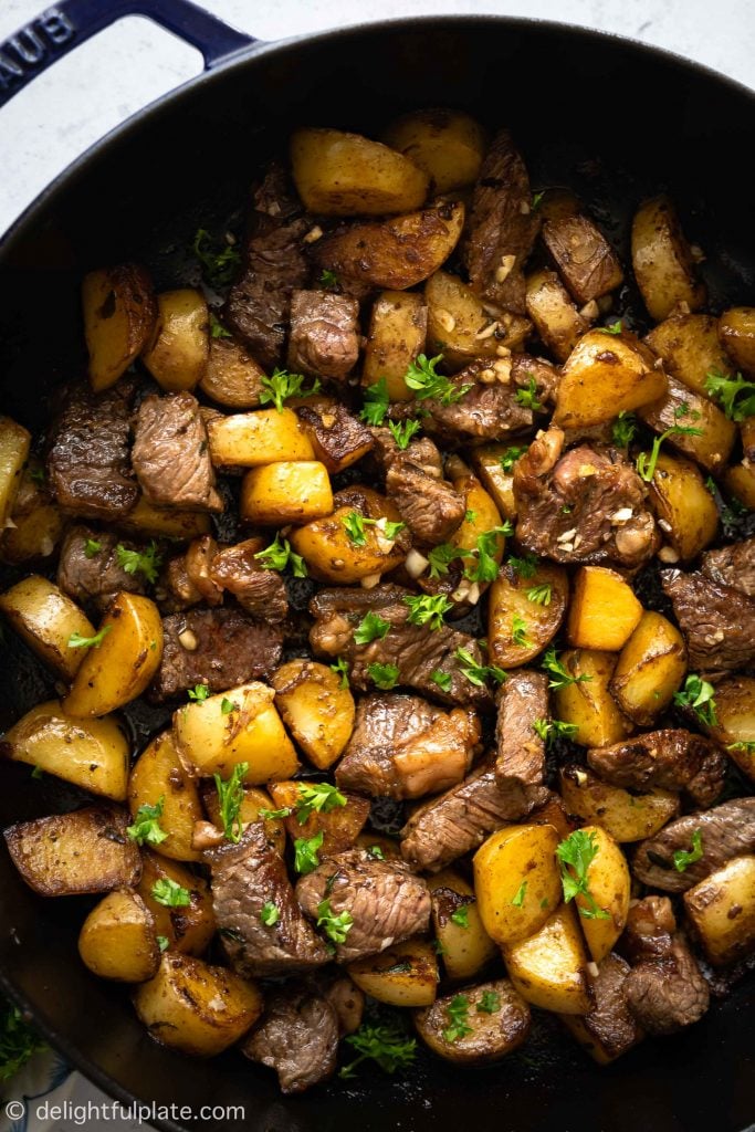 This Asian Steak Bites and Potatoes recipe features seared beef cubes and potatoes in a garlicky butter and soy-based sauce. It comes together in under 30 minutes and everything is cooked in just one pan. Easy weeknight dinner!