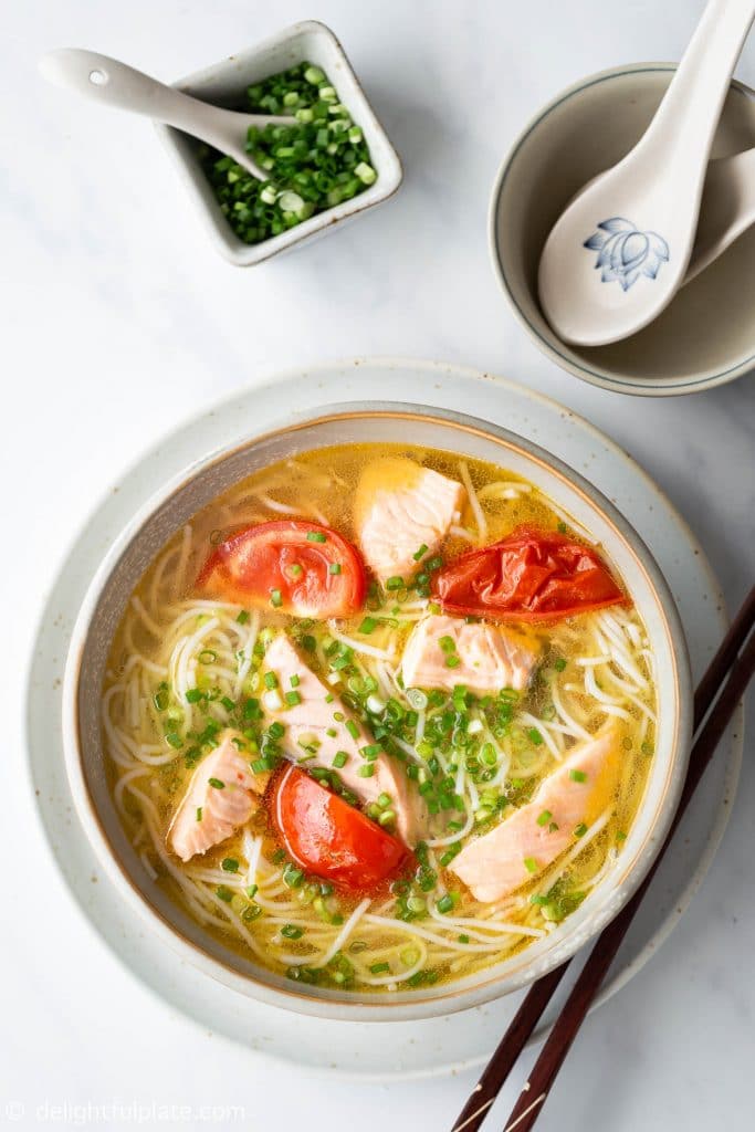 A bowl of Salmon Noodle Soup featuring a light yet flavorful Vietnamese-style broth and medium-cooked salmon chunks. It is delicious, healthy and ready in just 30 minutes.