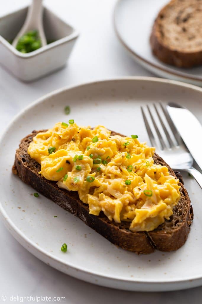 This Crab Scrambled Eggs is an easy and fancy breakfast to treat yourself on weekends or impress others on special occasions. Soft and fluffy egg curds served on a slice of whole wheat bread.