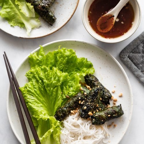 plates of Vietnamese grilled beef in betel leaves served with vermicelli noodles.
