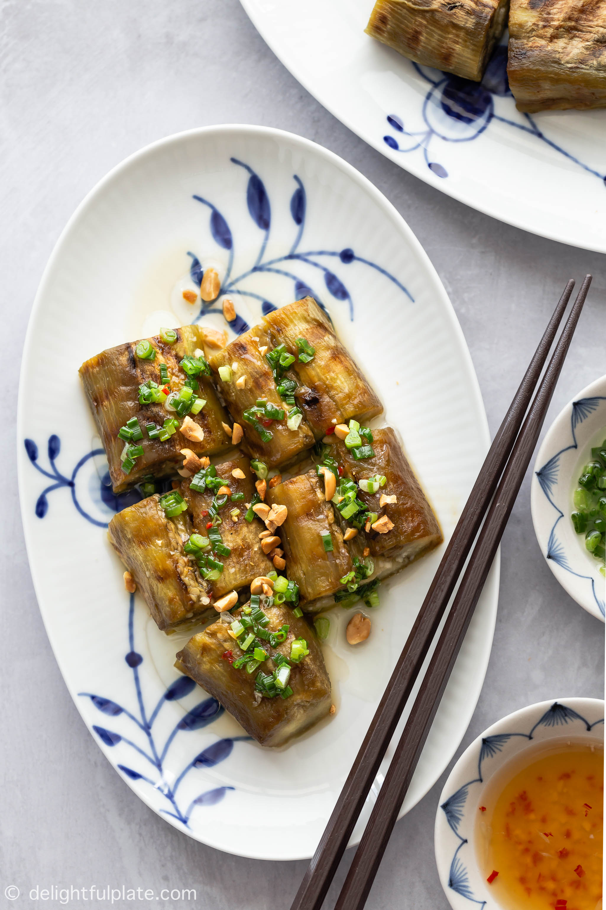 Vietnamese Grilled Eggplant with Scallion Oil (Ca Tim Nuong Mo Hanh) features whole eggplants grilled until charred and served with fragrant scallion oil, fish sauce dressing and roasted peanuts.