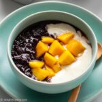Black Sticky Rice Pudding cooked in a pressure cooker, then served with yogurt and mango