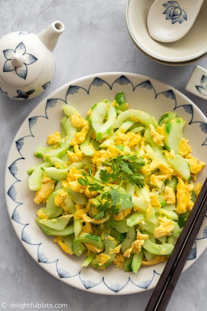 A plate of cucumber slices stir fried with garlic and eggs.