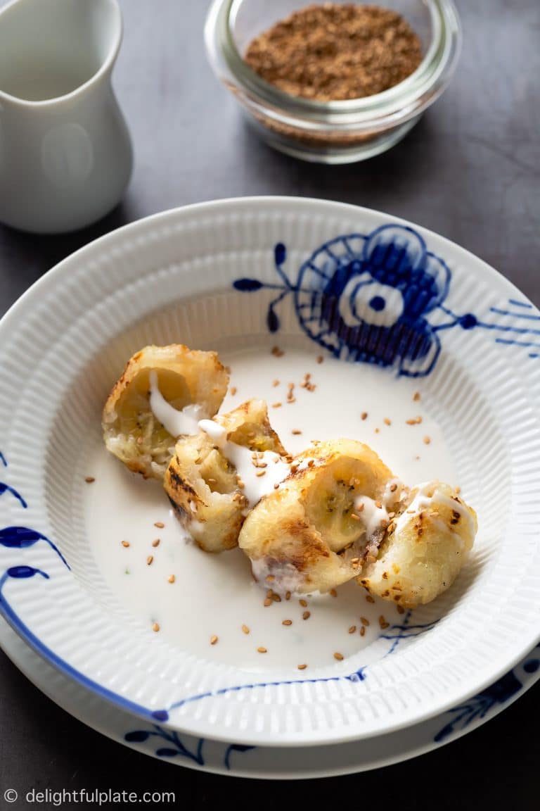 a plate of Vietnamese grilled banana sticky rice in coconut milk