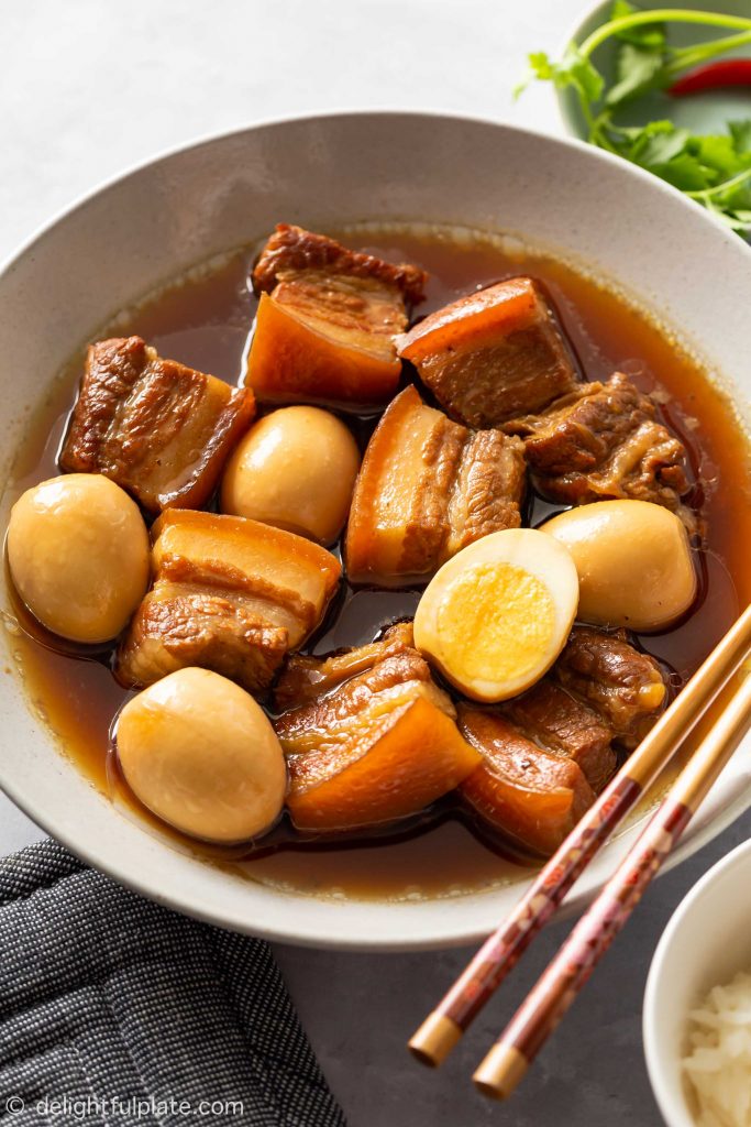 a plate of Vietnamese caramelized pork belly and eggs (thit kho trung), served with white rice.