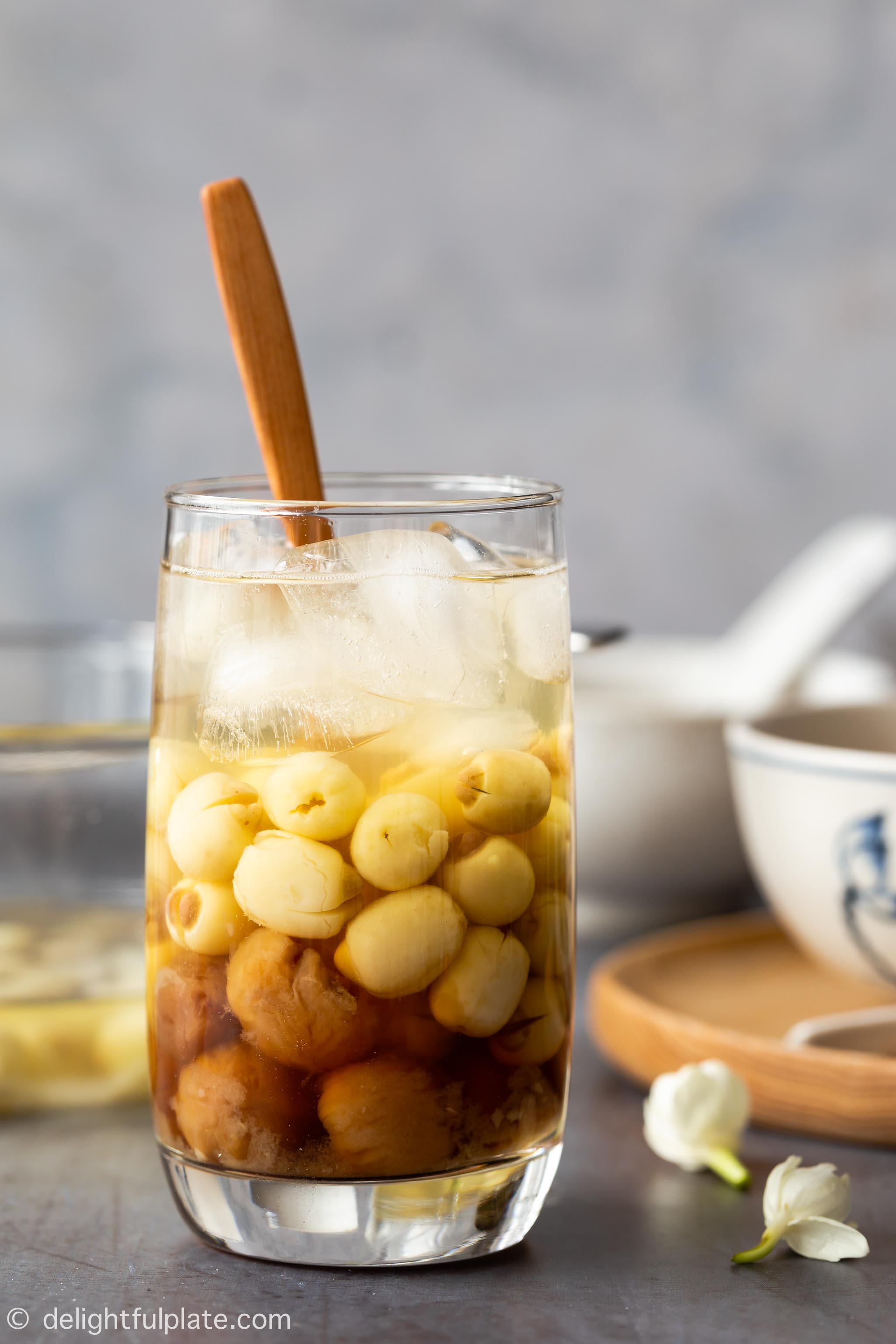 a serving glass with longan, lotus seed soup and ice