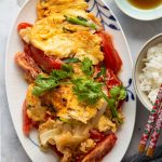 a plate of Vietnamese omelet with tomato and onion