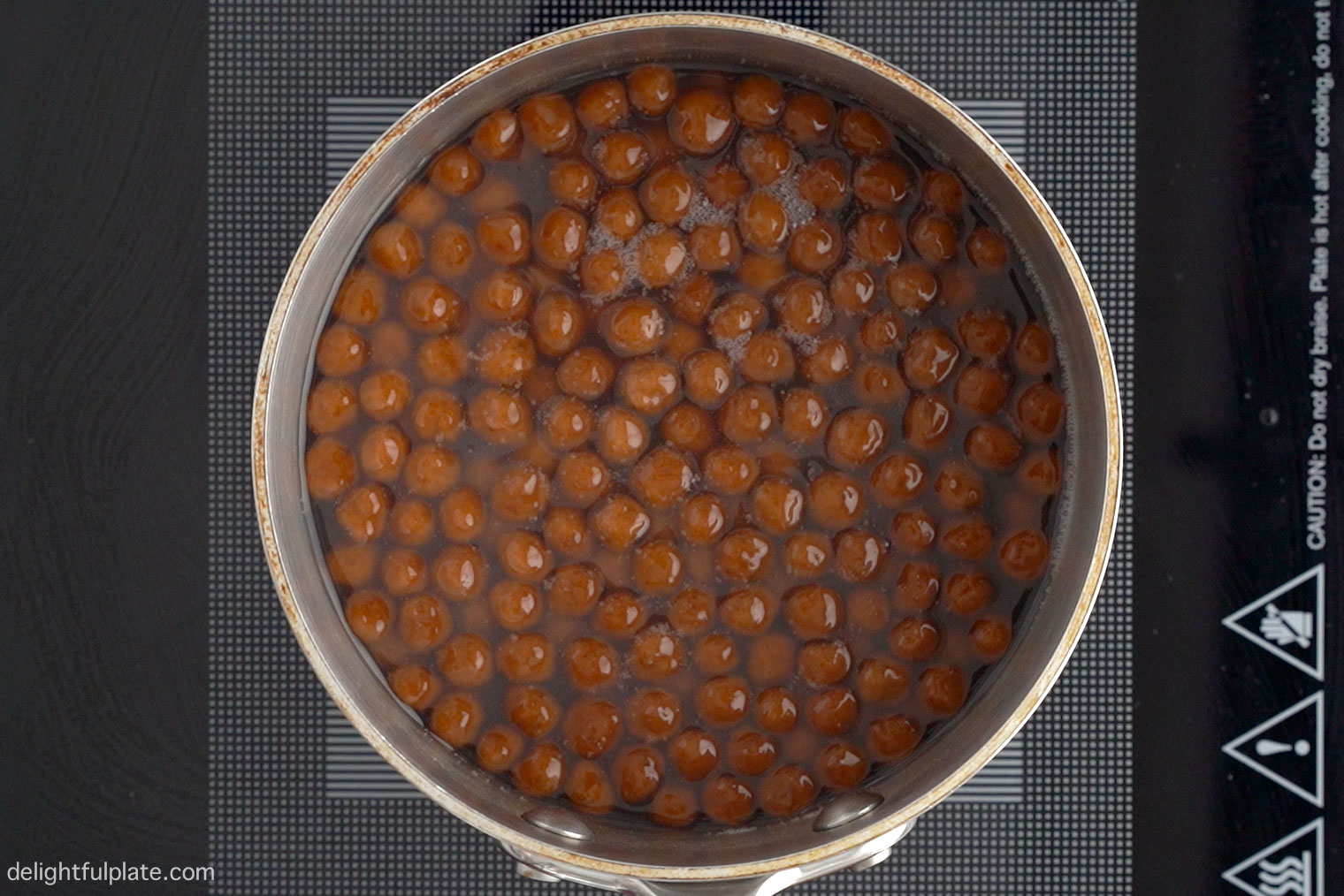 Boba pearls being boiled in a pot