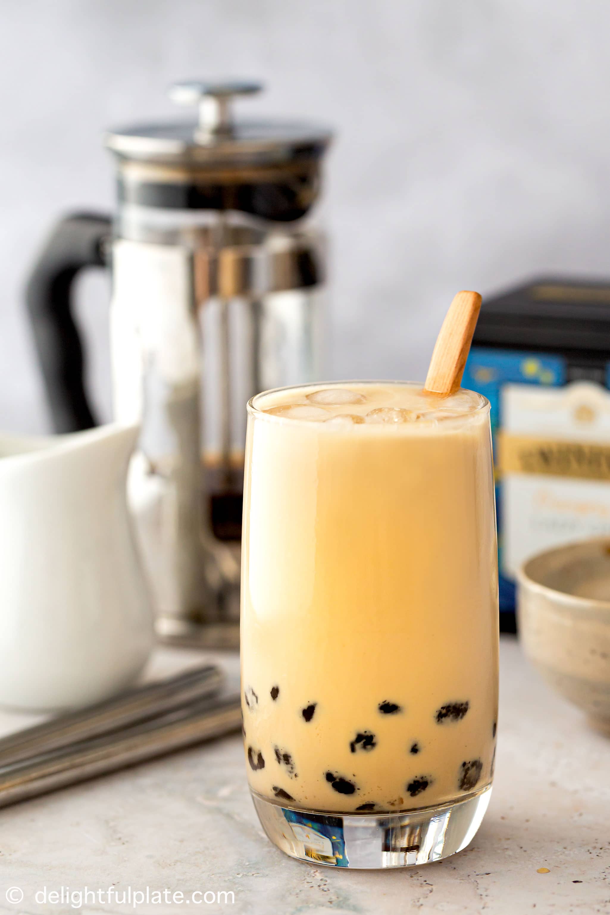 A glass of brown sugar milk tea with tapioca pearls