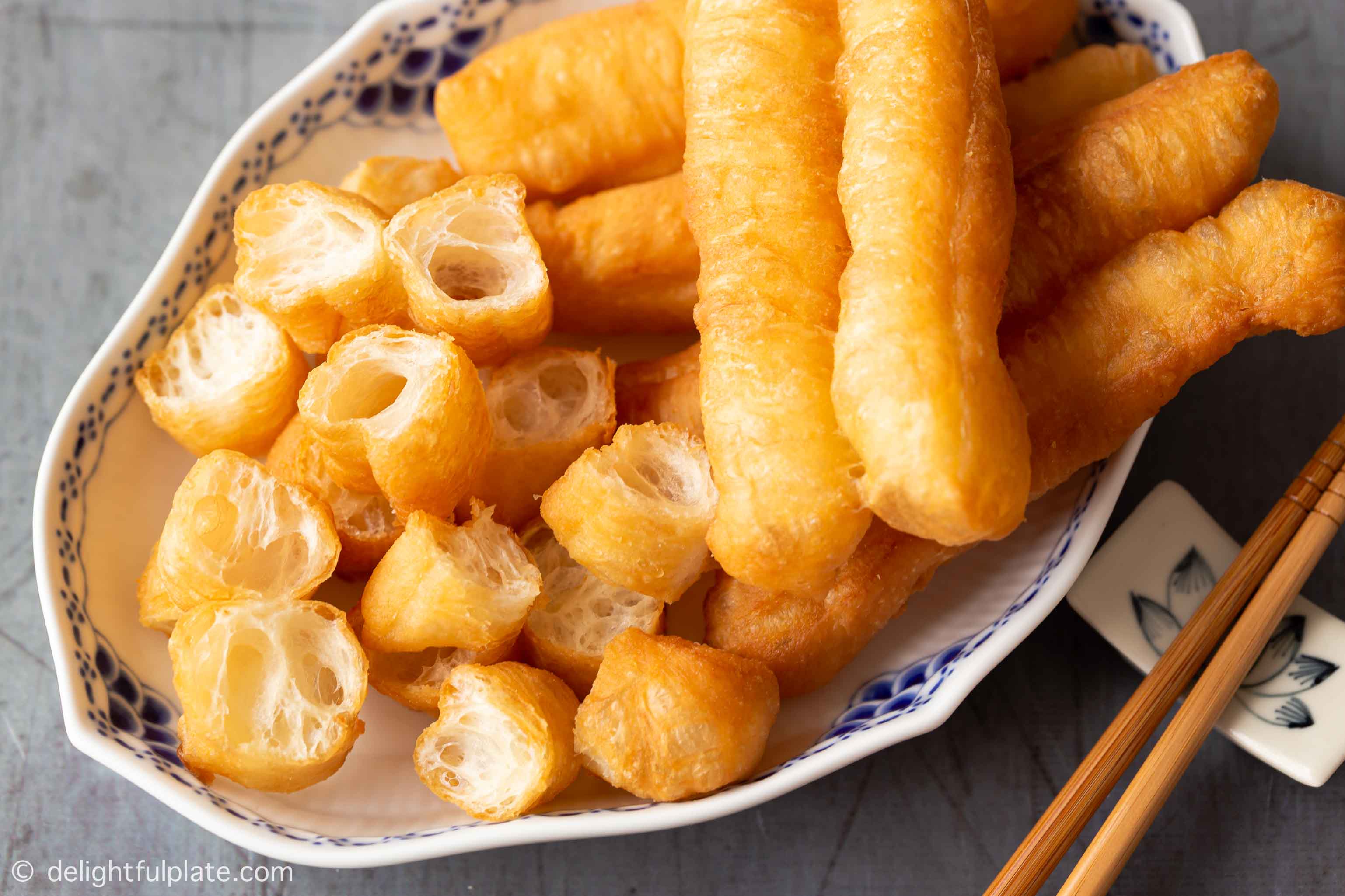 golden fried dough sticks (youtiao in Chinese and quẩy in Vietnamese) on a serving plate