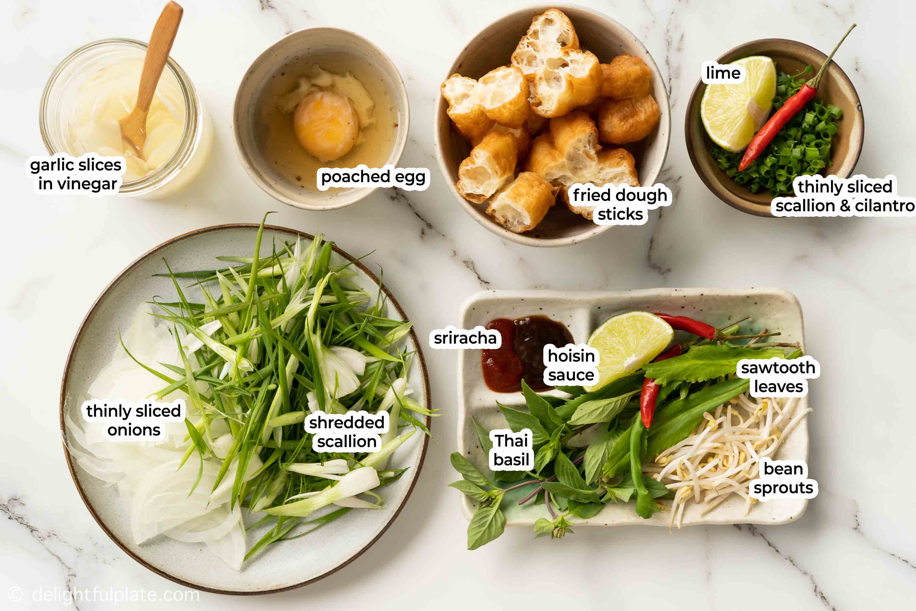 plates and bowls with accompaniments for Vietnamese beef pho noodle soup