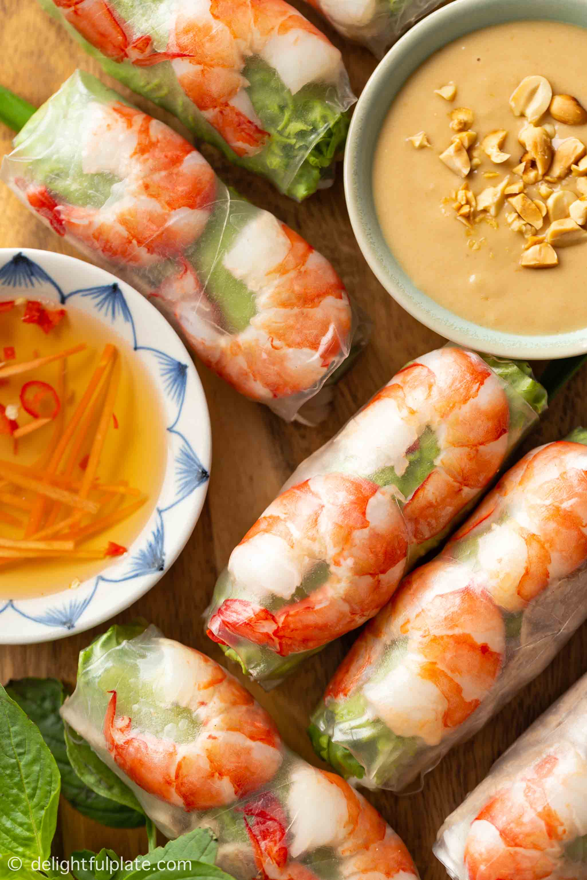 a serving plate with Vietnamese summer rolls and two types of dipping sauce