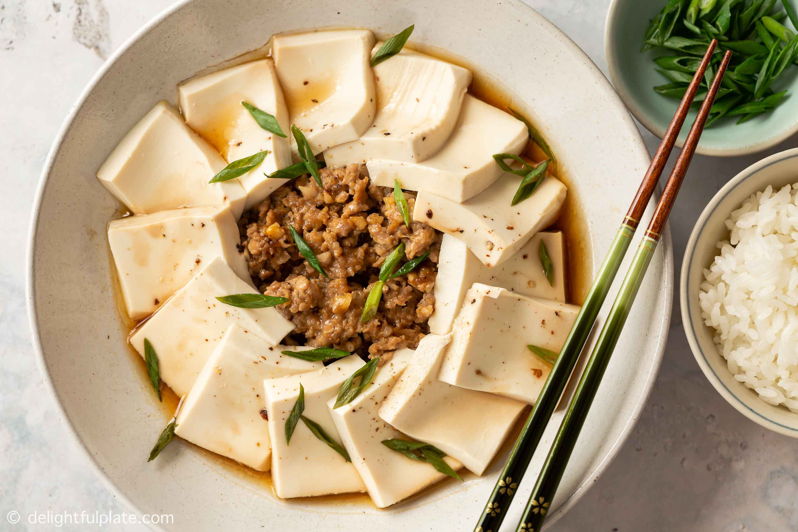 a plate of steamed tofu with minced pork