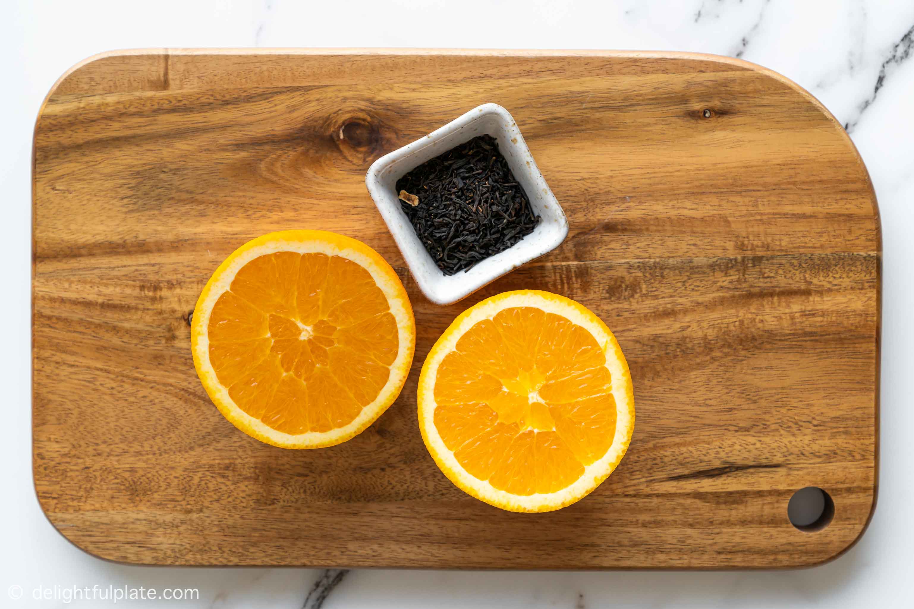 a tray with an orange and some black tea