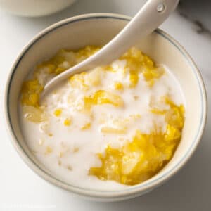 a bowl of Vietnamese Sweet Corn Pudding cooked from shaved corn kernels and sticky rice