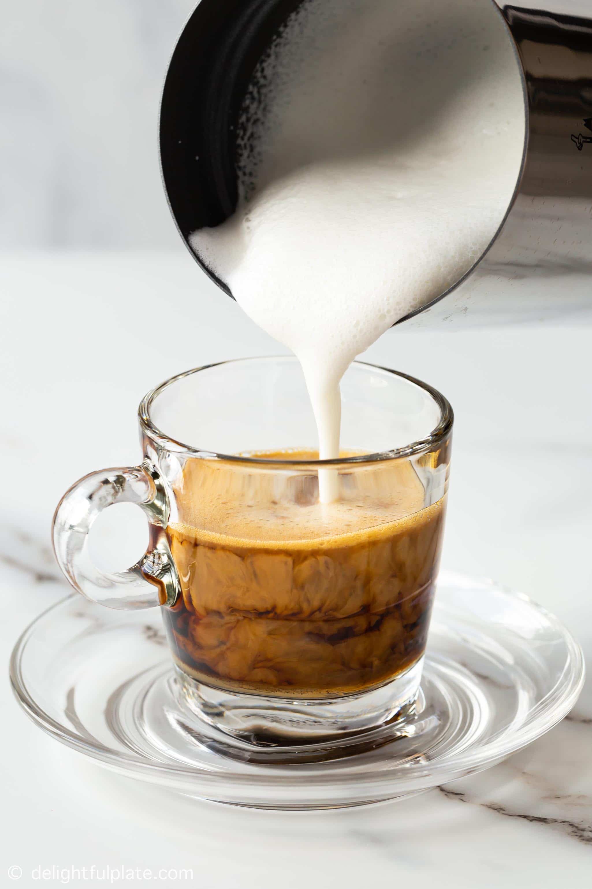 pouring milk into ginger coffee