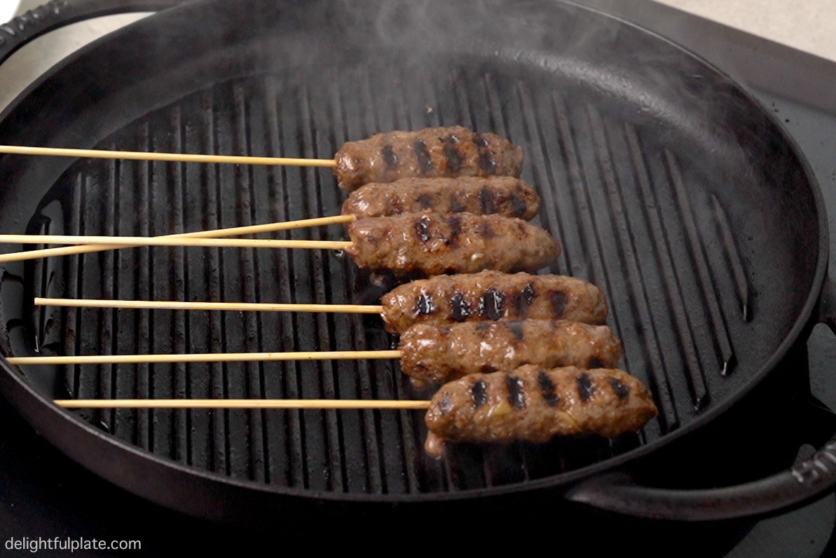 grilling the beef skewers on a grill pan