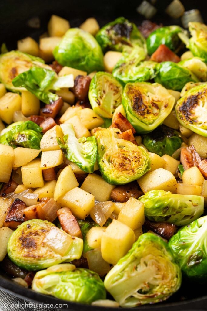 a pan of Sautéed Brussels Sprouts with Bacon and apple