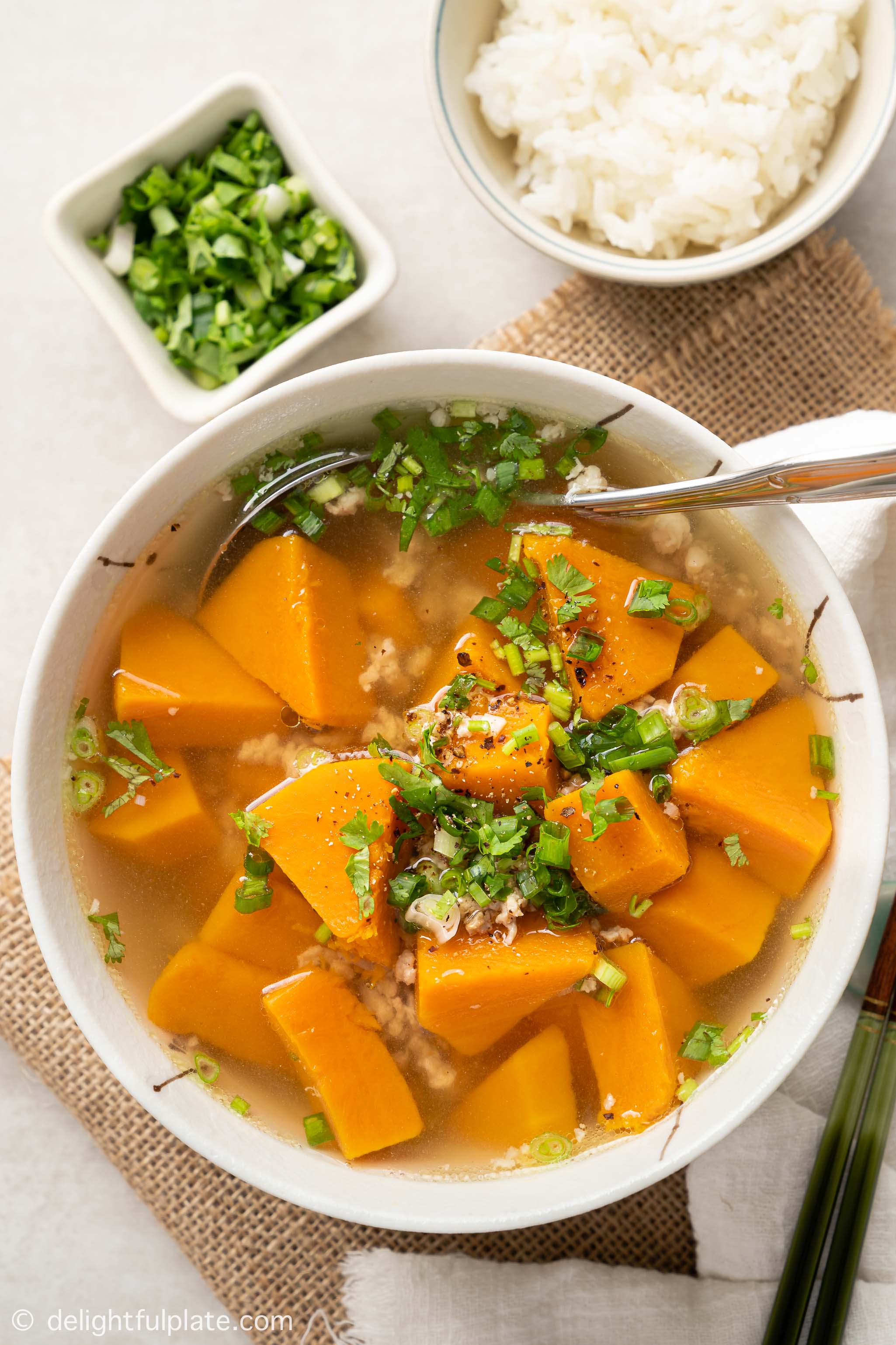 a bowl of Vietnamese pumpkin soup (canh bi do), served with rice