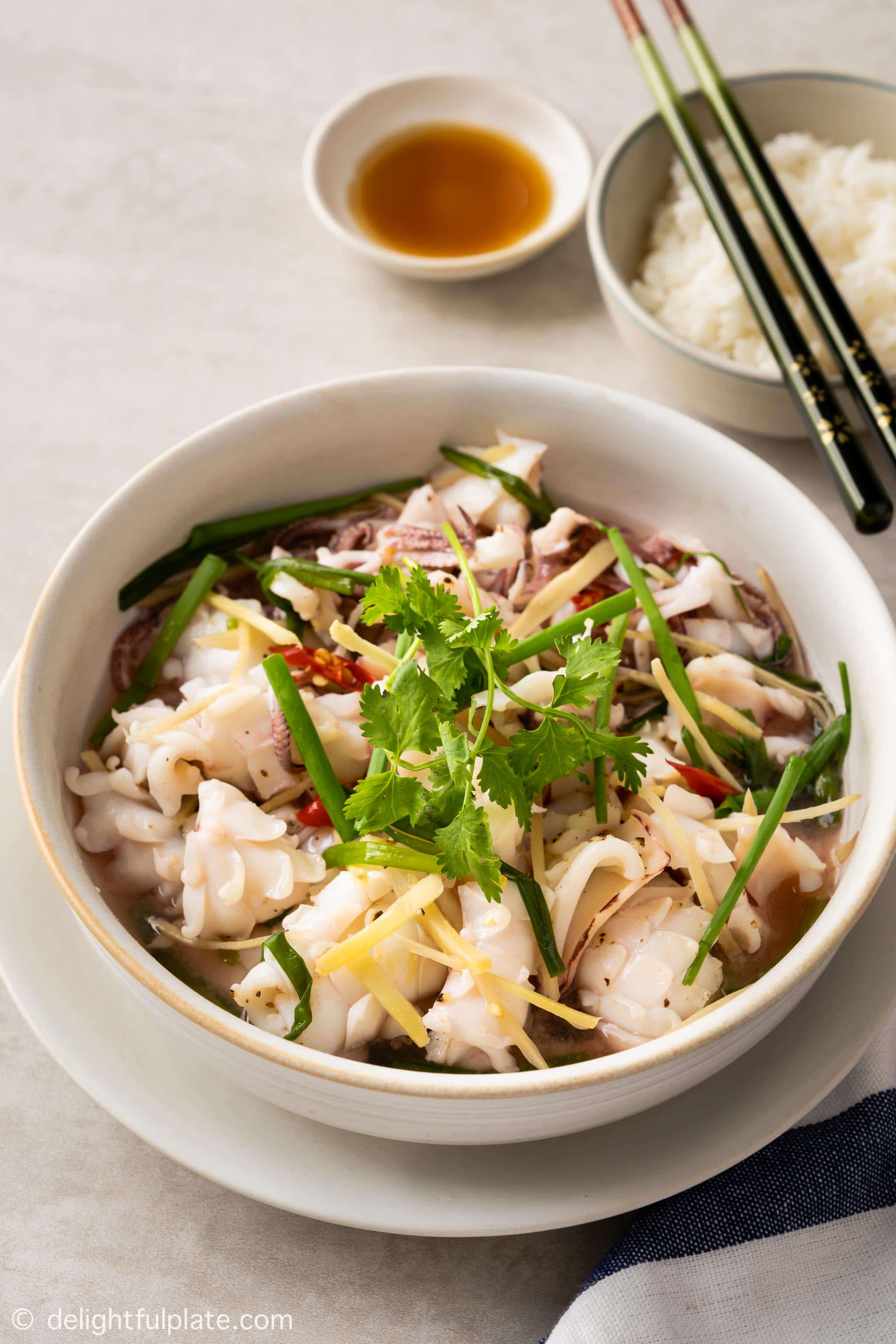 a bowl of steamed squid, served with fish sauce and rice