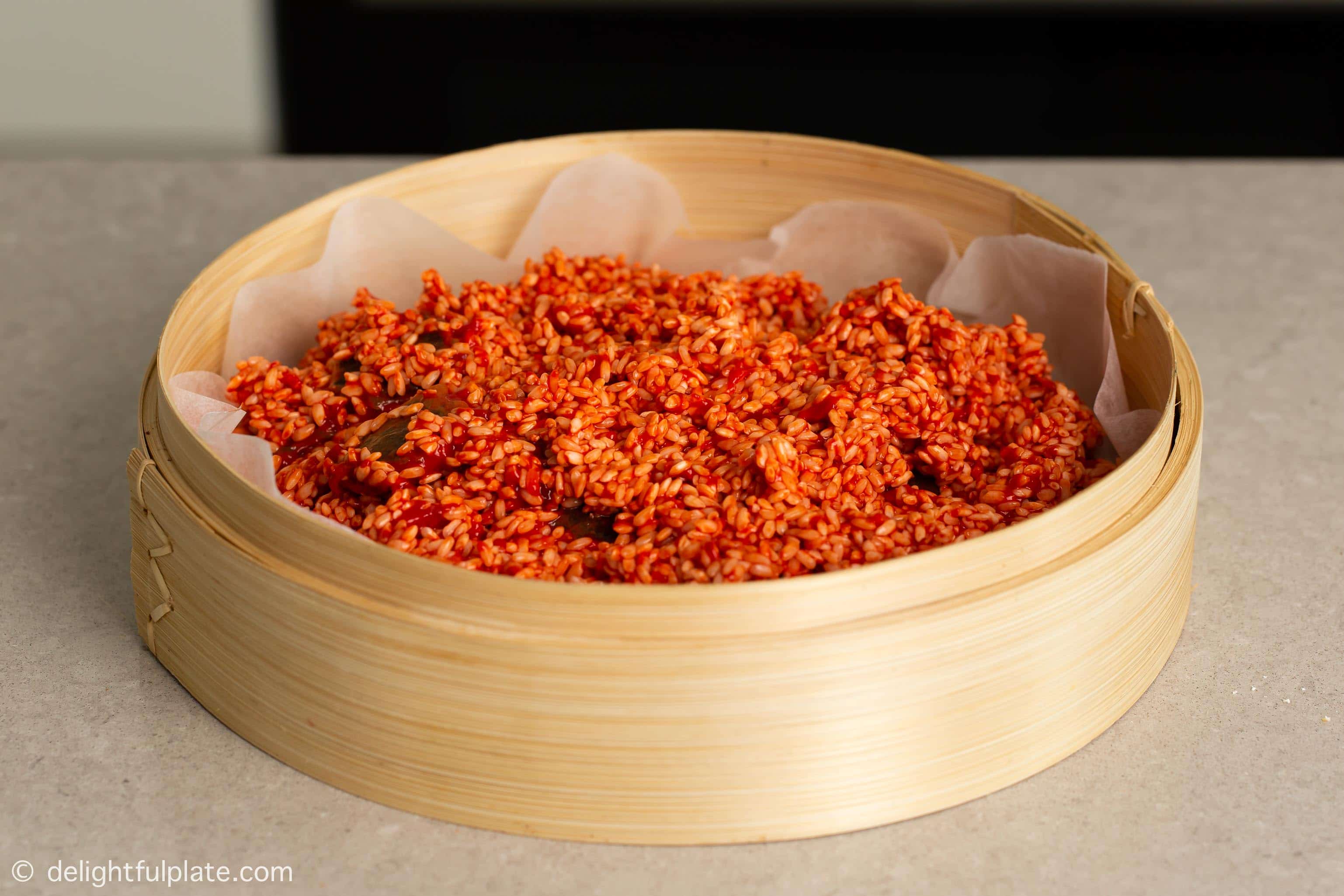 sticky rice that has been mixed with the red paste before steaming