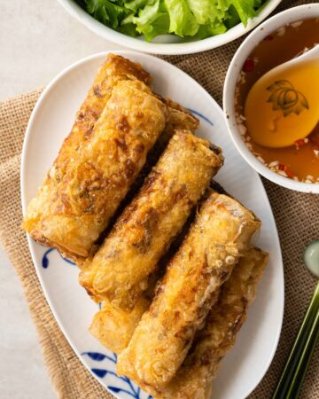 a plate of Vietnamese crispy spring rolls, served with dipping sauce
