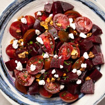 a plate of Roasted Beetroot Salad with Goat Cheese, Walnut and Cherry Tomato
