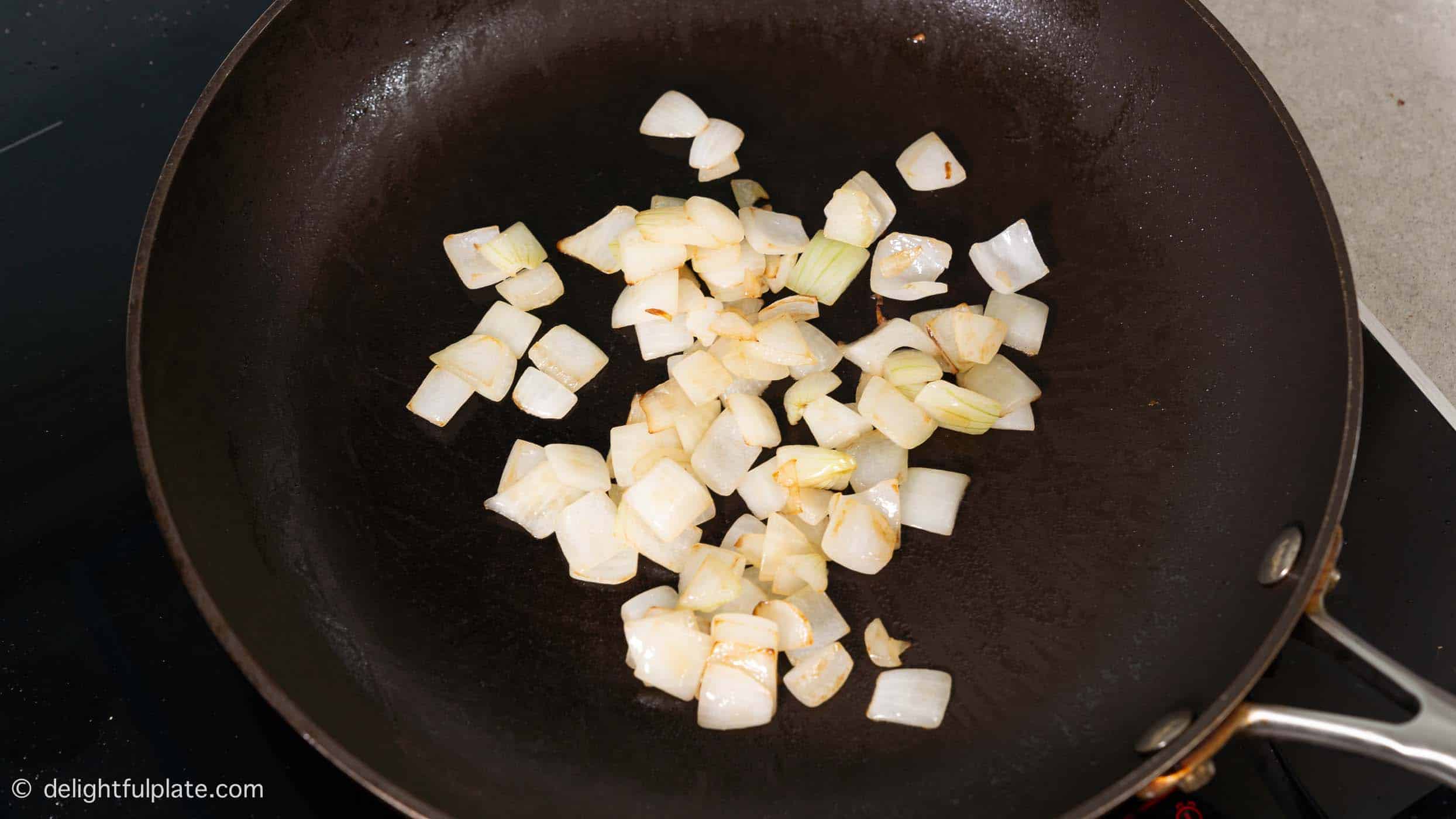 cooking diced onion in a skillet.