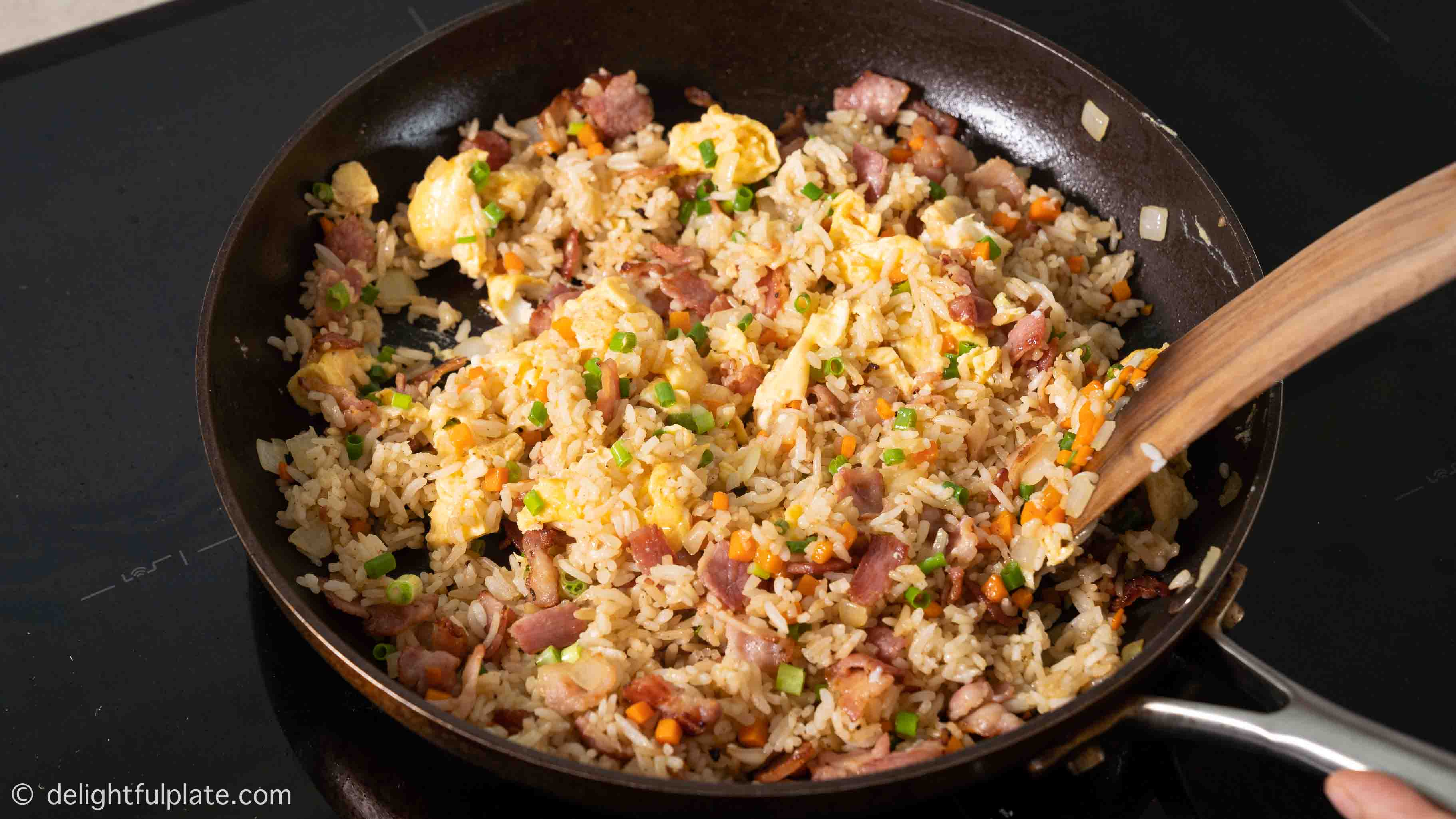 a pan of bacon fried rice after cooking
