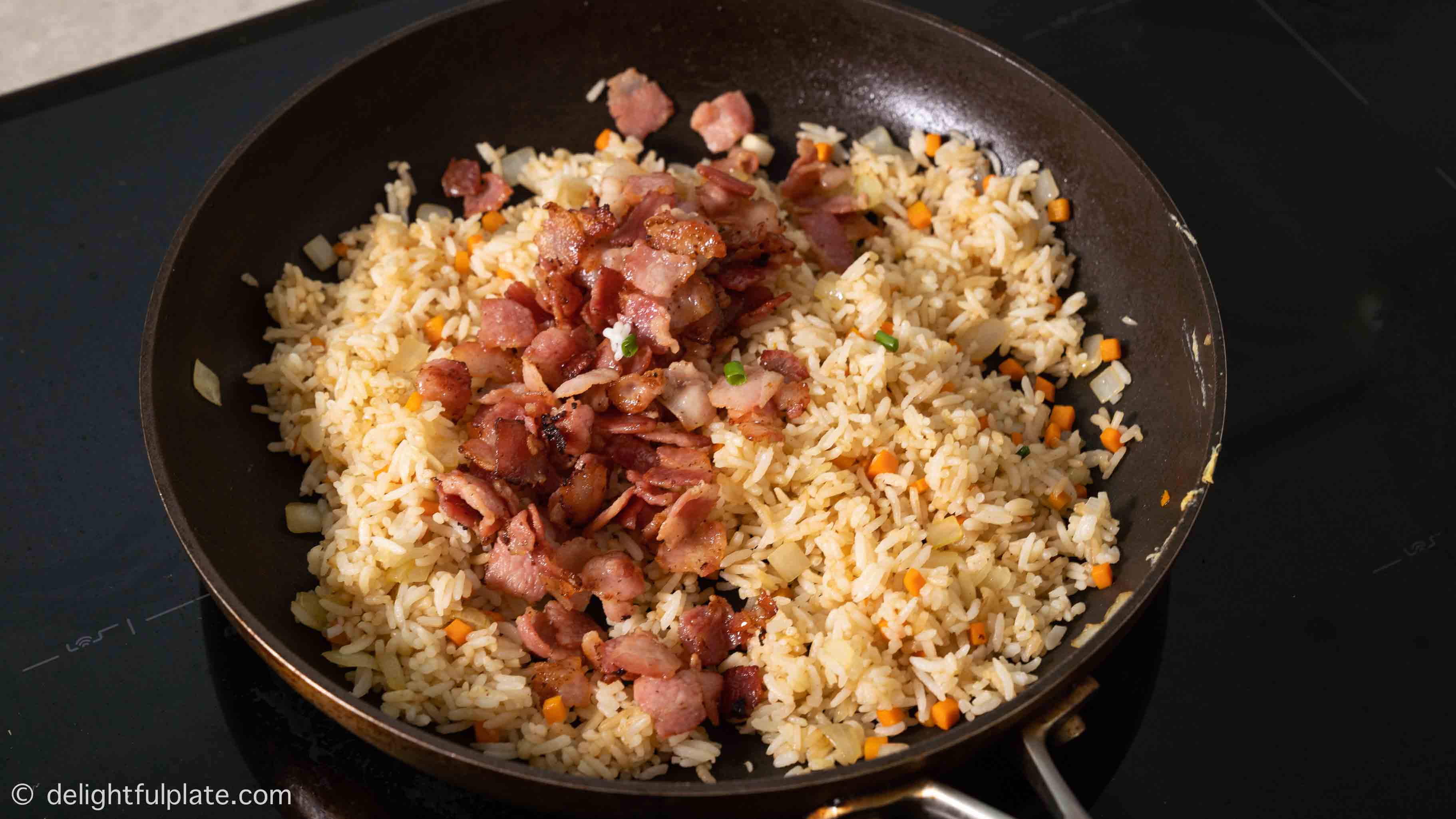 adding cooked bacon to the pan
