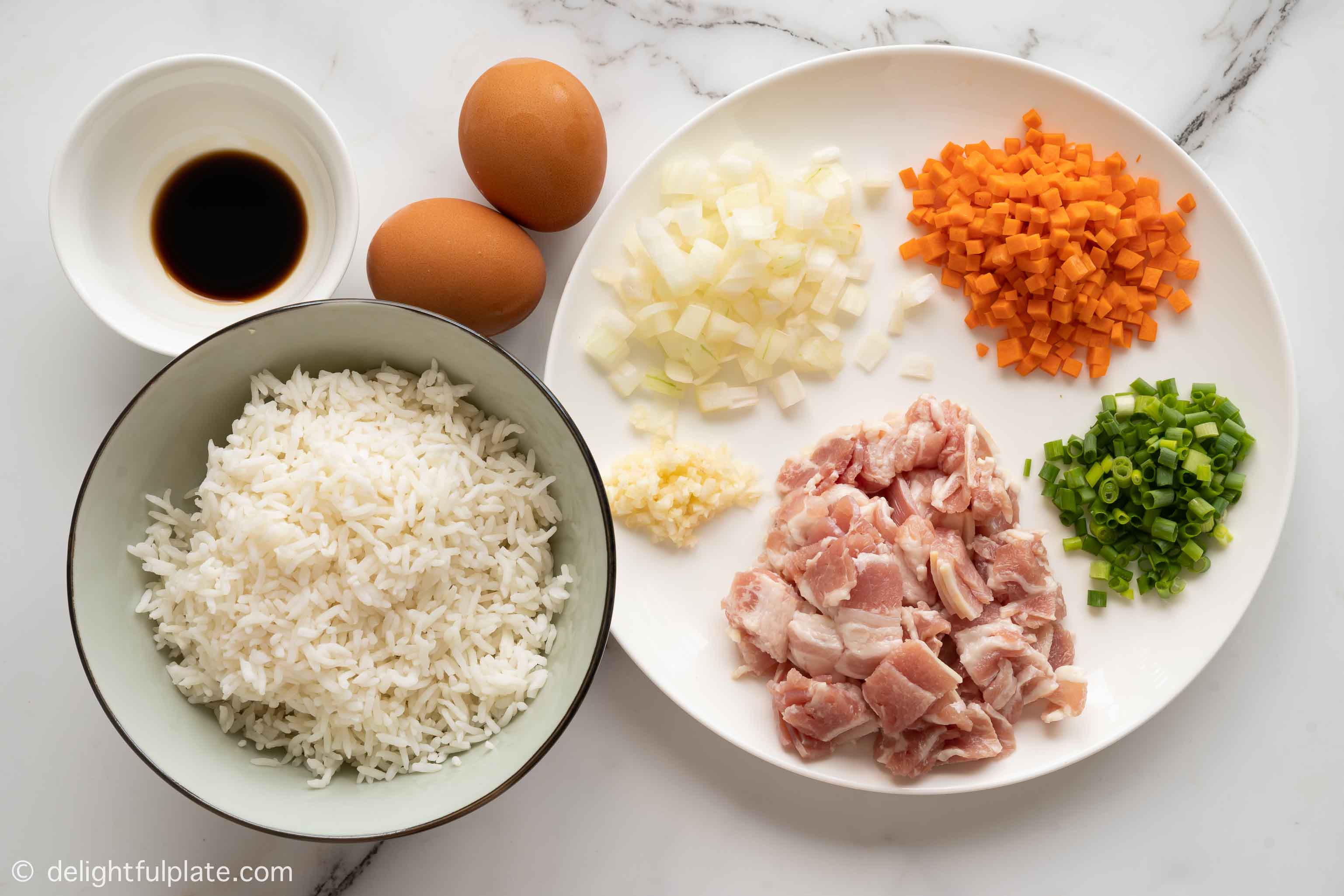 plates with ingredients for bacon fried rice