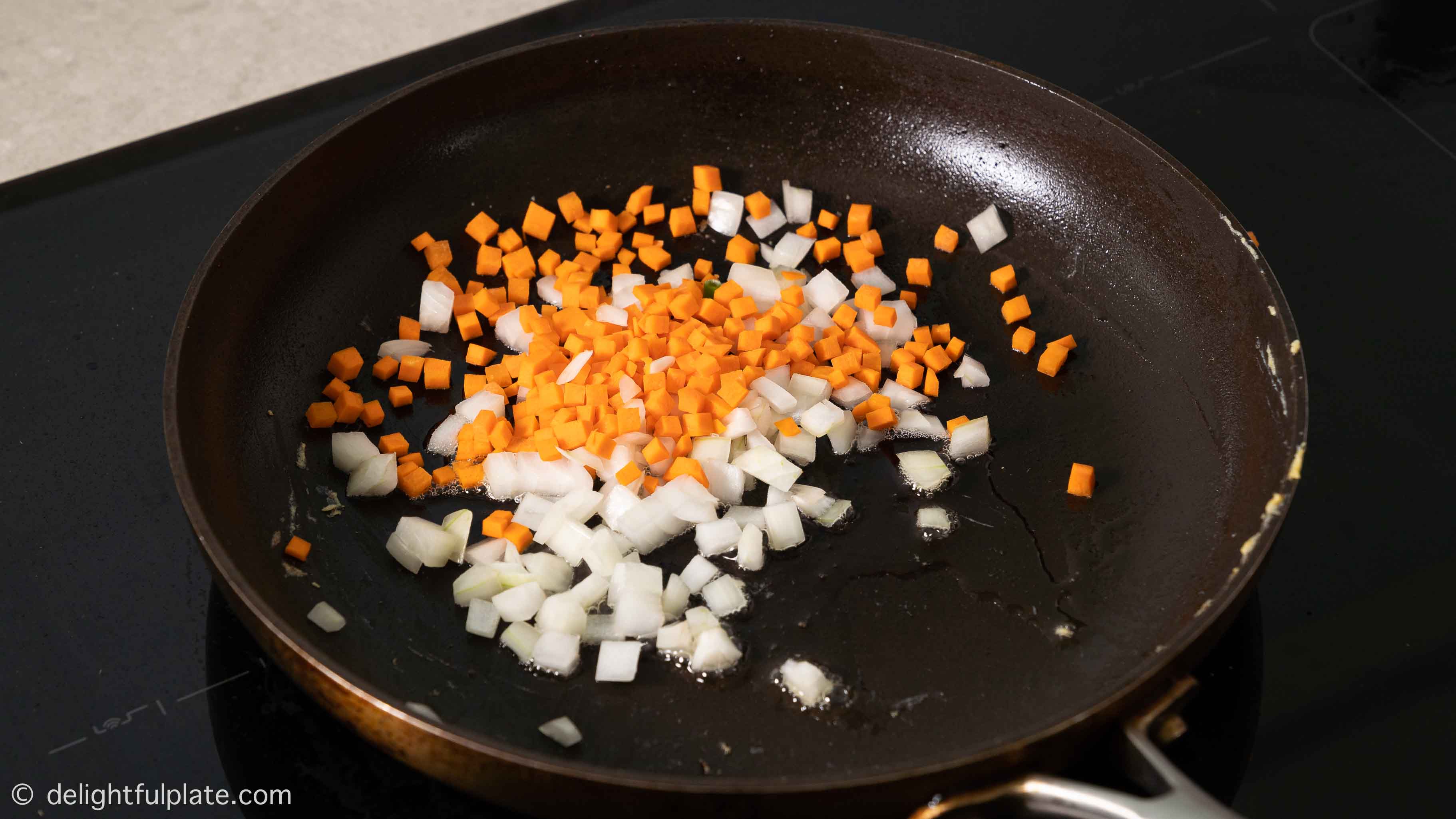 adding diced vegetables to the pan