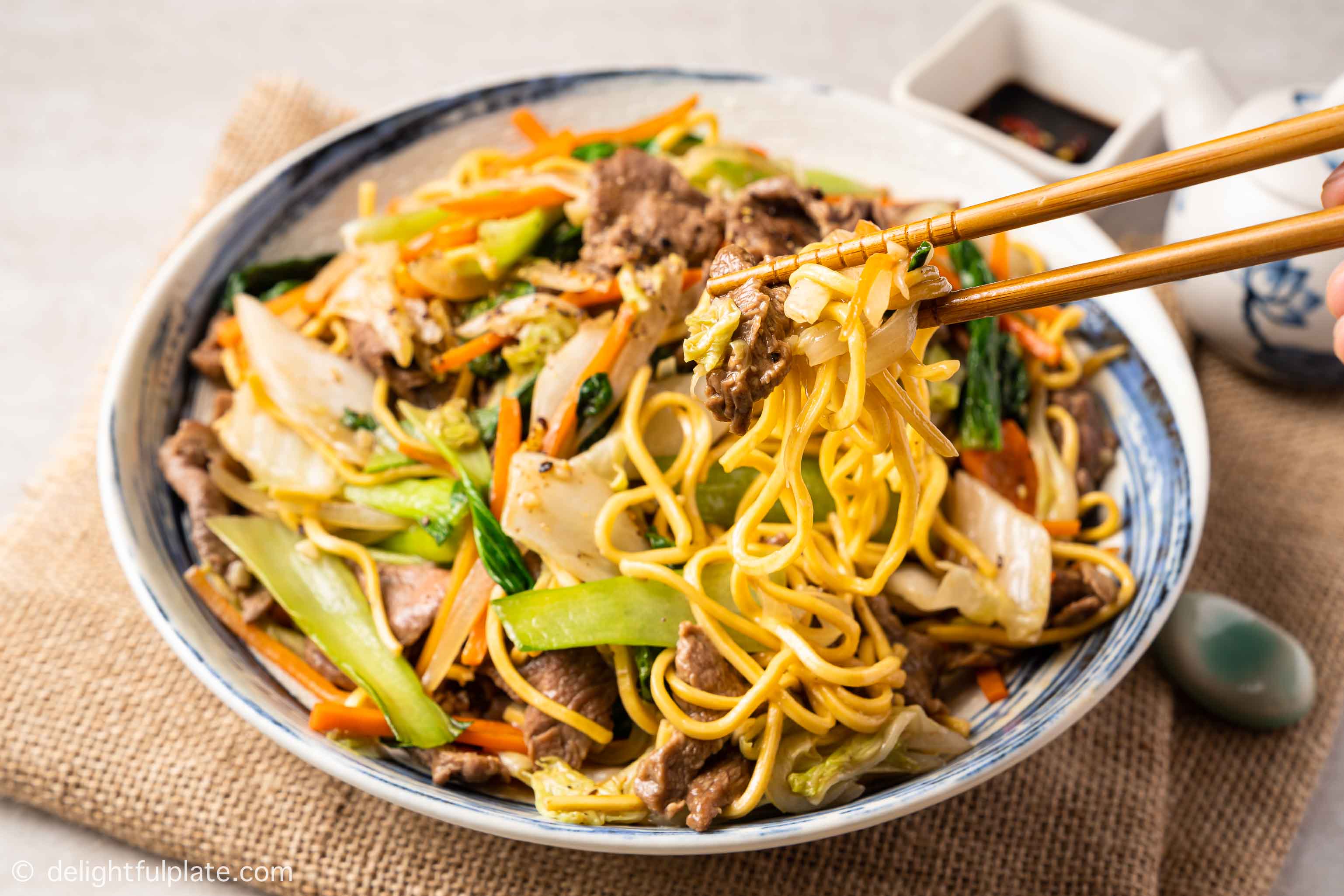a bowl of beef noodle stir fry (beef chow mein)