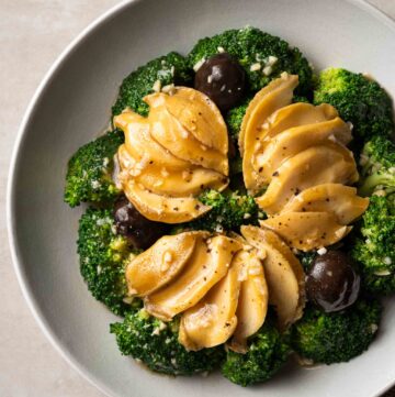 a plate of braised abalone with broccoli in oyster sauce
