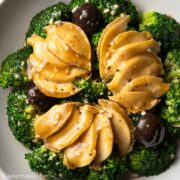 a plate of braised abalone and broccoli in oyster sauce
