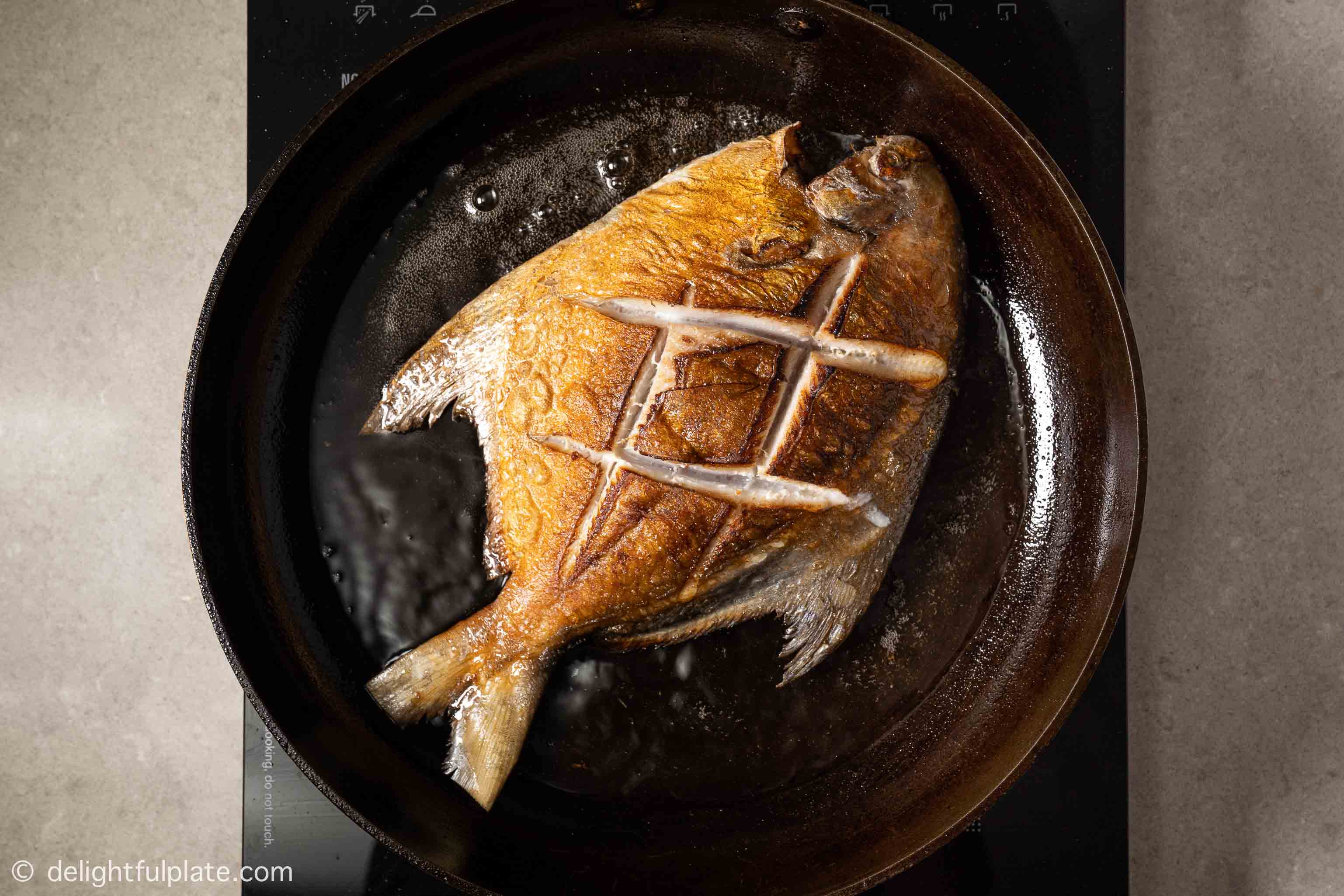 frying the fish in a pan
